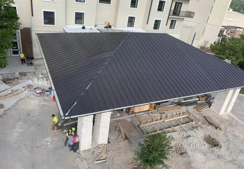 Metal roofing installation team working on a commercial building in Crestview