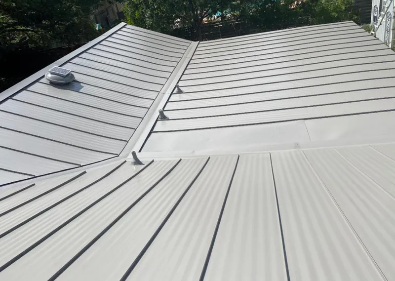 Solar attic fan installed on a metal roof for Roof Ventilation in Crestview